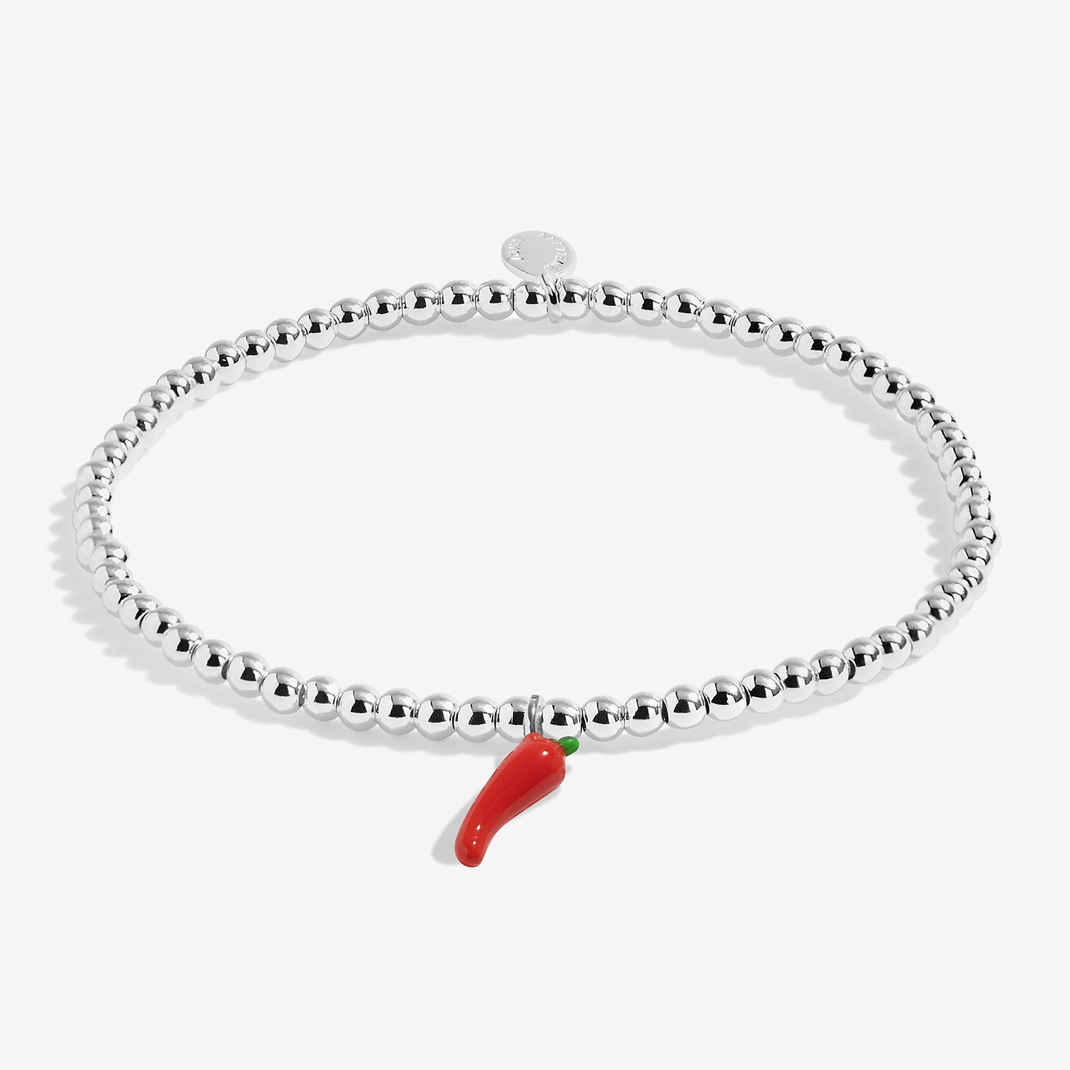 A silver-plated joma jewellery beaded stretch bracelet with a small red chili pepper charm, shown on a light gray background.