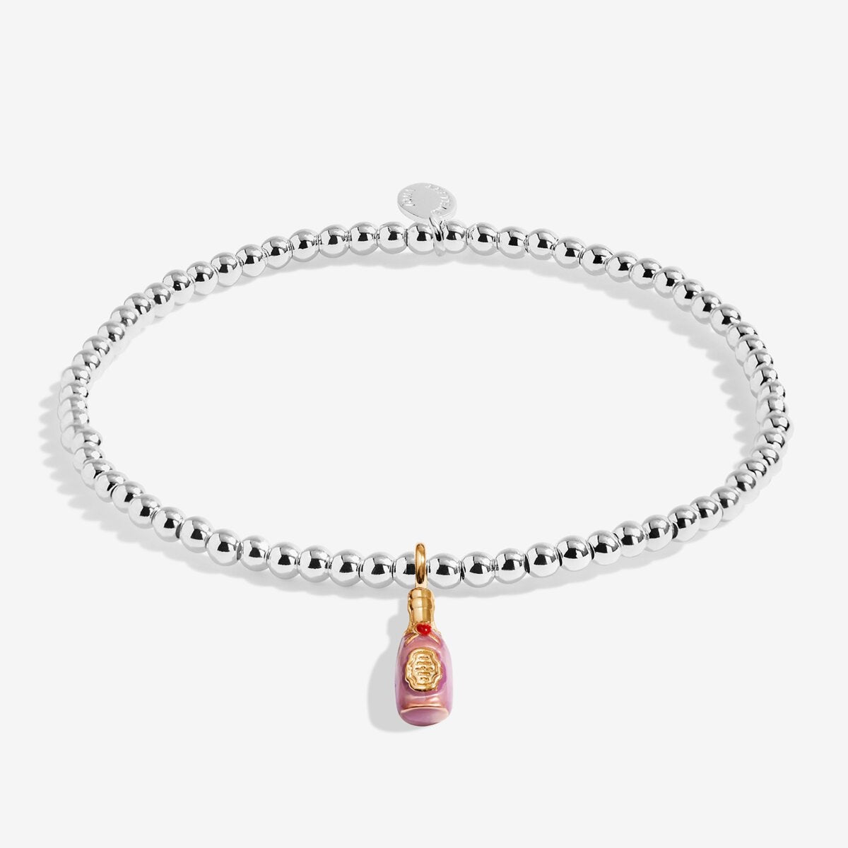 A silver beaded stretch bracelet with a dangling pink Champagne bottle charm featuring gold detailing, shown on a light white background.