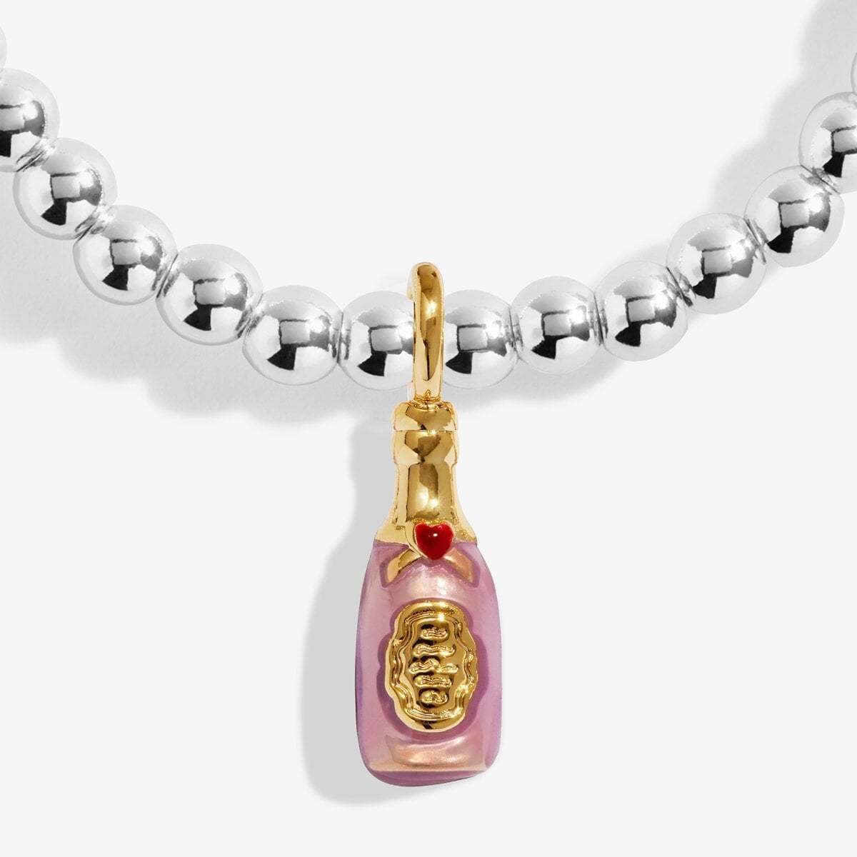 Silver beaded bracelet with a pink and gold prosecco charm on a white background