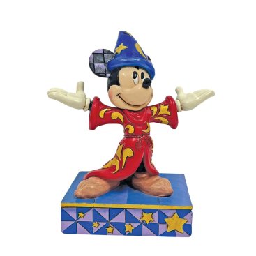 A figurine of Sorcerer Mickey Mouse wearing a red and blue outfit with gold accents, standing on a base with blue and yellow stars.
