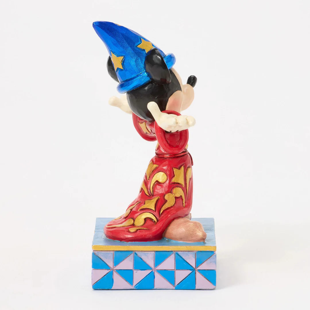 Colorful figurine of a character with a blue hat and red outfit on a geometric-patterned base.