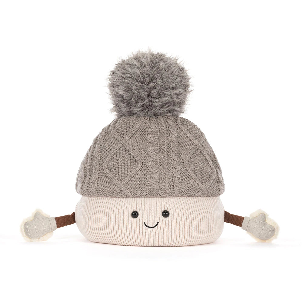 Jellycat amuseables pomilly hat with a gray cable-knit top, a cream ribbed bottom, a gray pom-pom, and small fabric hands and feet, shown on a white background.