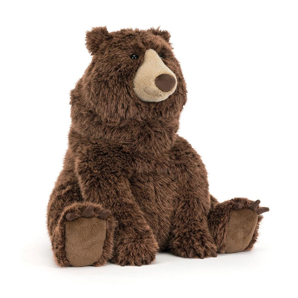 Bizzlestomp is a brown plush stuffed bear by jellycat. Sitting upright on a clean white background.