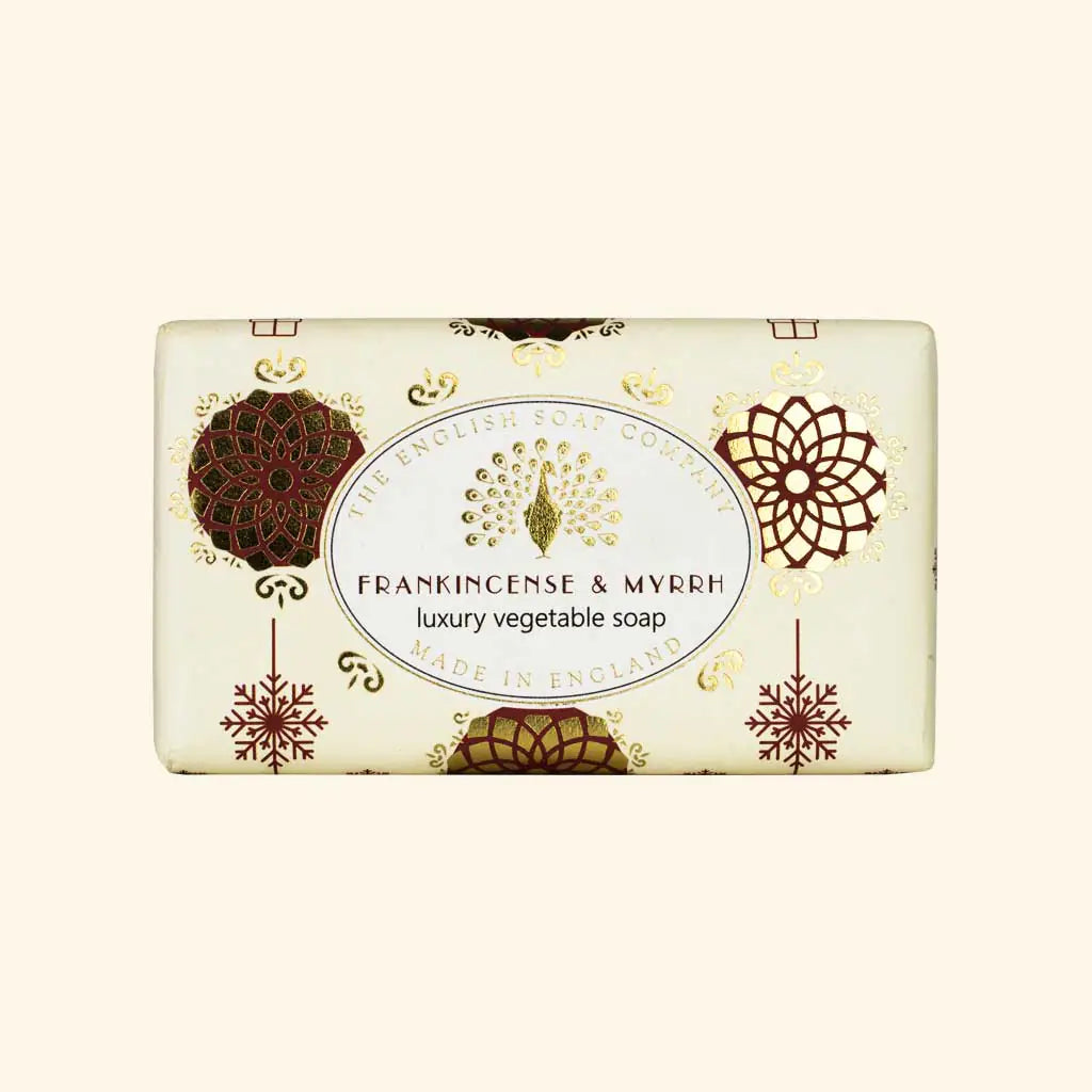 A rectangular bar of luxury vegetable soap from The English Soap Company, named Frankincense & Myrrh. The soap bar is cream-colored with elegant gold and dark brown ornamental patterns and a central white oval label.