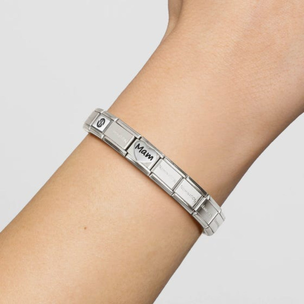 Silver Nomination bracelet with a heart mam family charm. On a person's wrist against a light grey background. (Bracelet Sold Separate)
