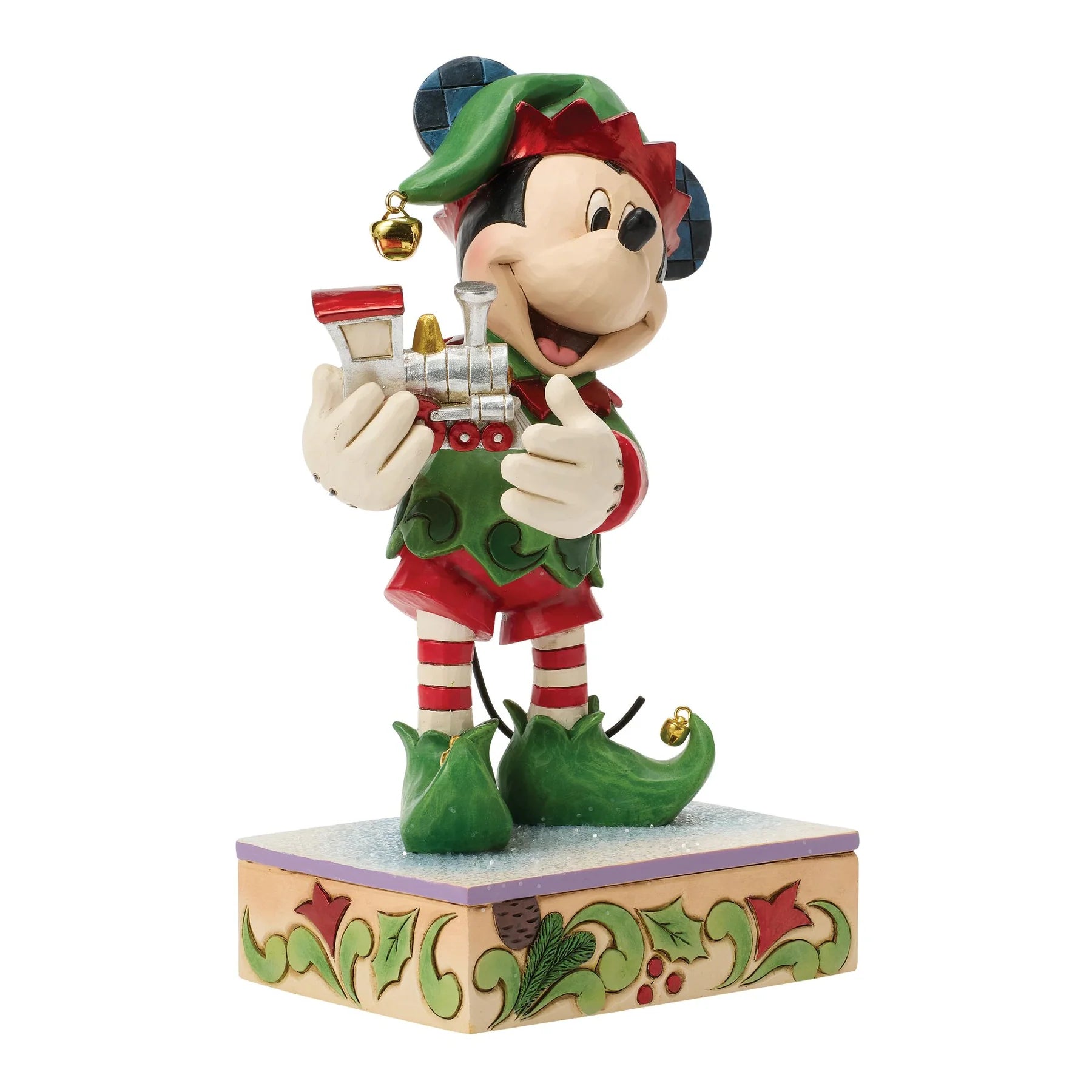 mickey mouse Disney character figurine dressed as an elf holding a train on a decorative base.