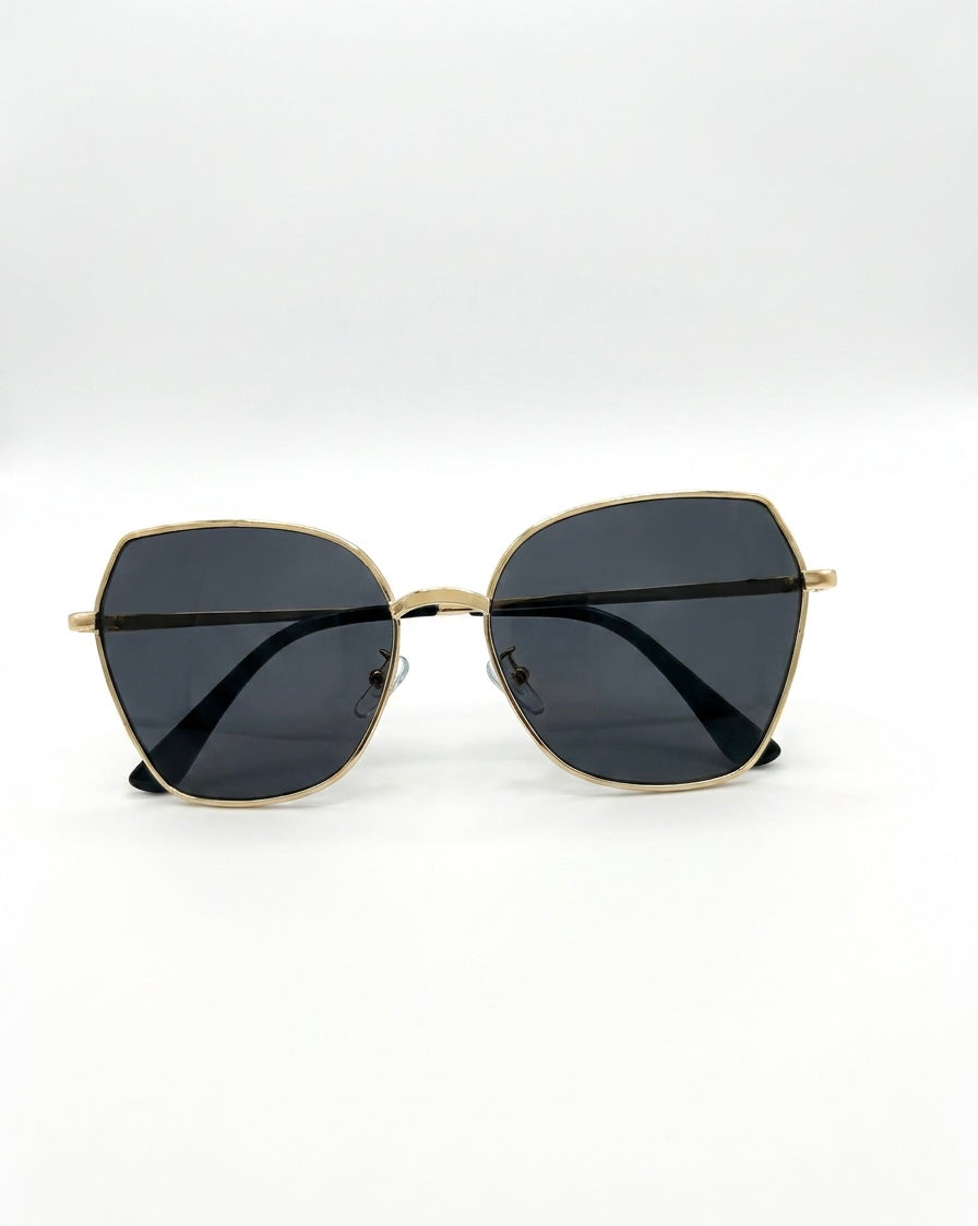 Gold-framed sunglasses with black lenses on a white background