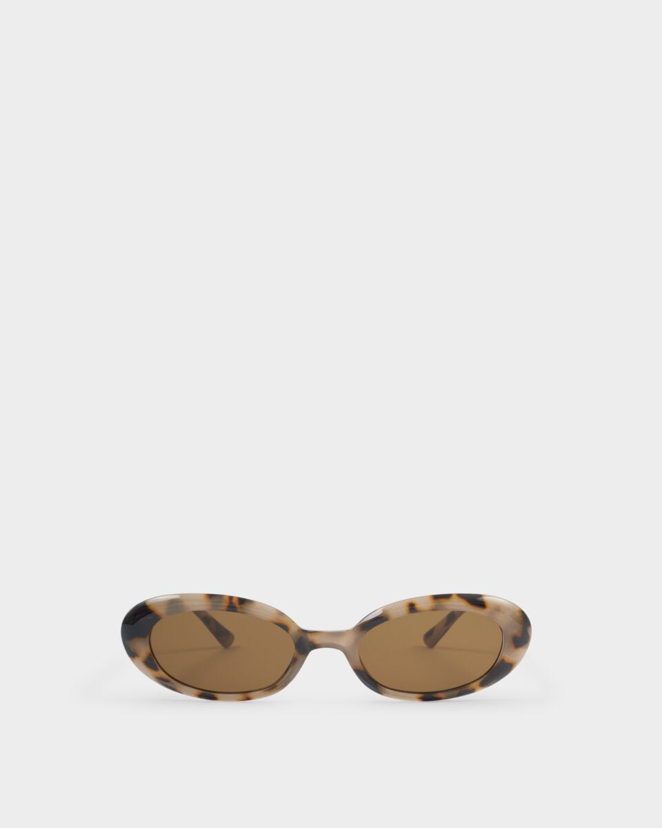 Sunglasses with tortoiseshell frame and brown lenses on a white background