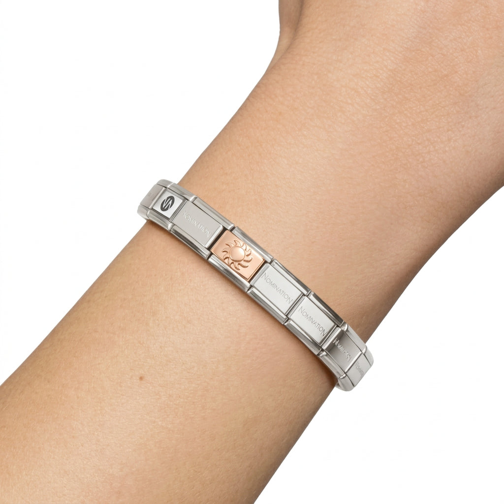 Silver nomination composable bracelet, showcasing the rose gold and silver enamel sun charm. (Bracelet Sold separately).