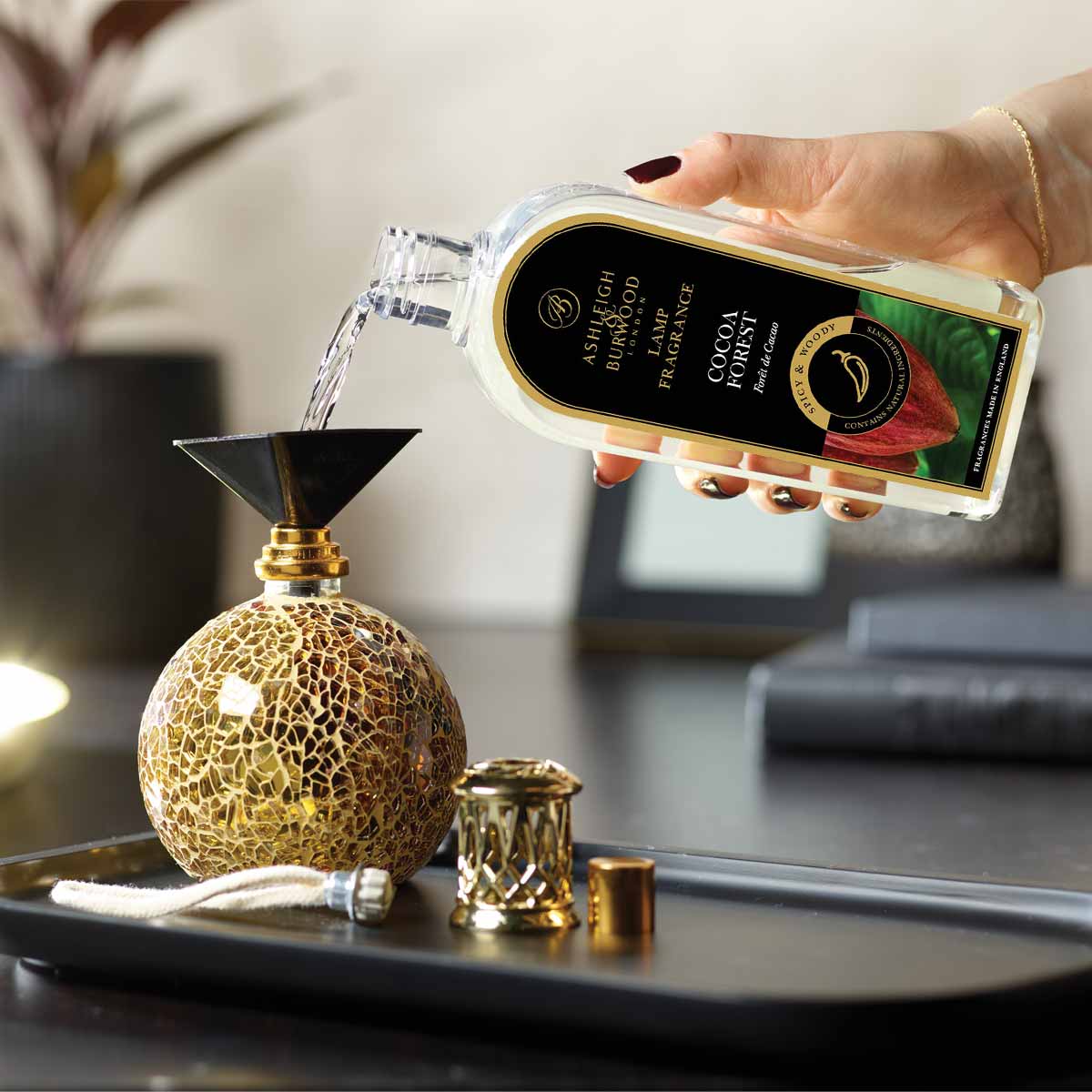 Cocoa Forest Lamp Fragrance being poured into a Fragrance Lamp