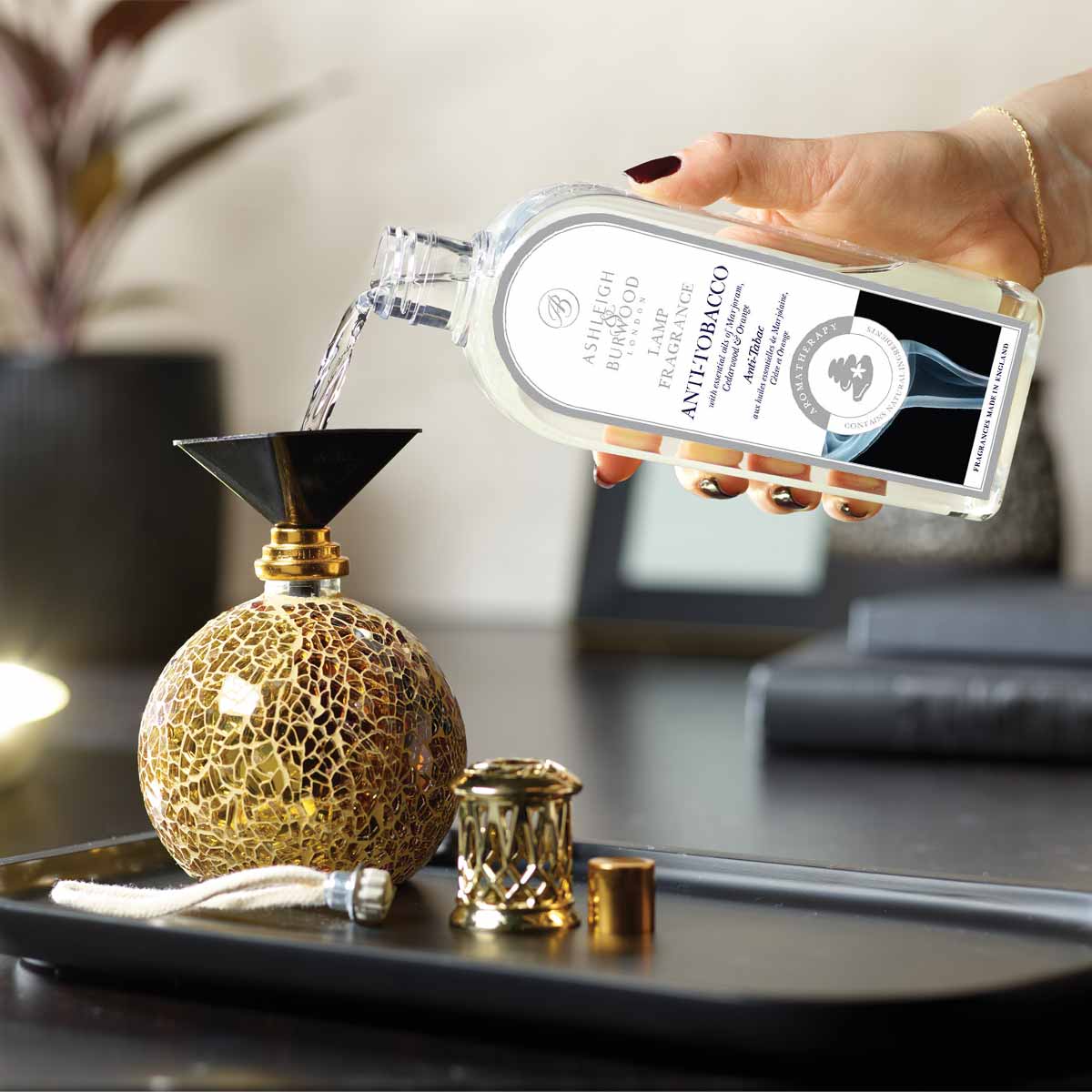 Anti-Tobacco Lamp Fragrance being poured into a Fragrance Lamp