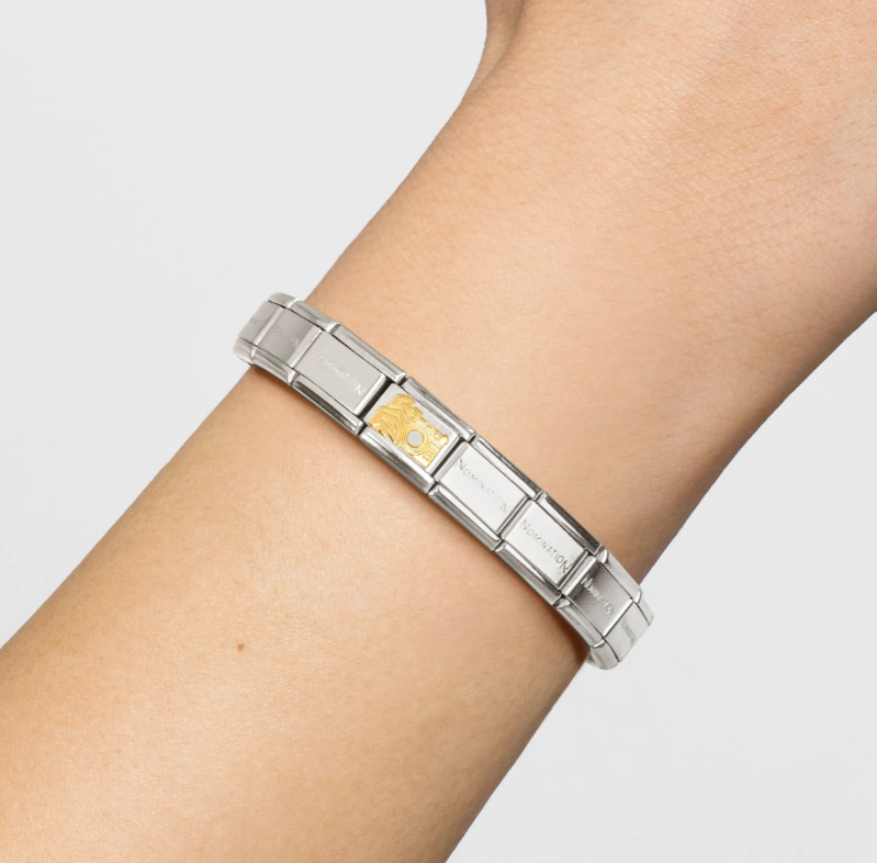 Nomination Italy Gold 030108/17 Classic S/Steel,bonded yellow gold Camera with Hand. Attached to composable bracelet on a females wrist.
