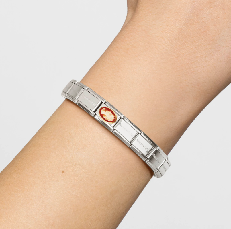 classic Nomination Italy Cameo composable charm connected to bracelet on a persons wrist.