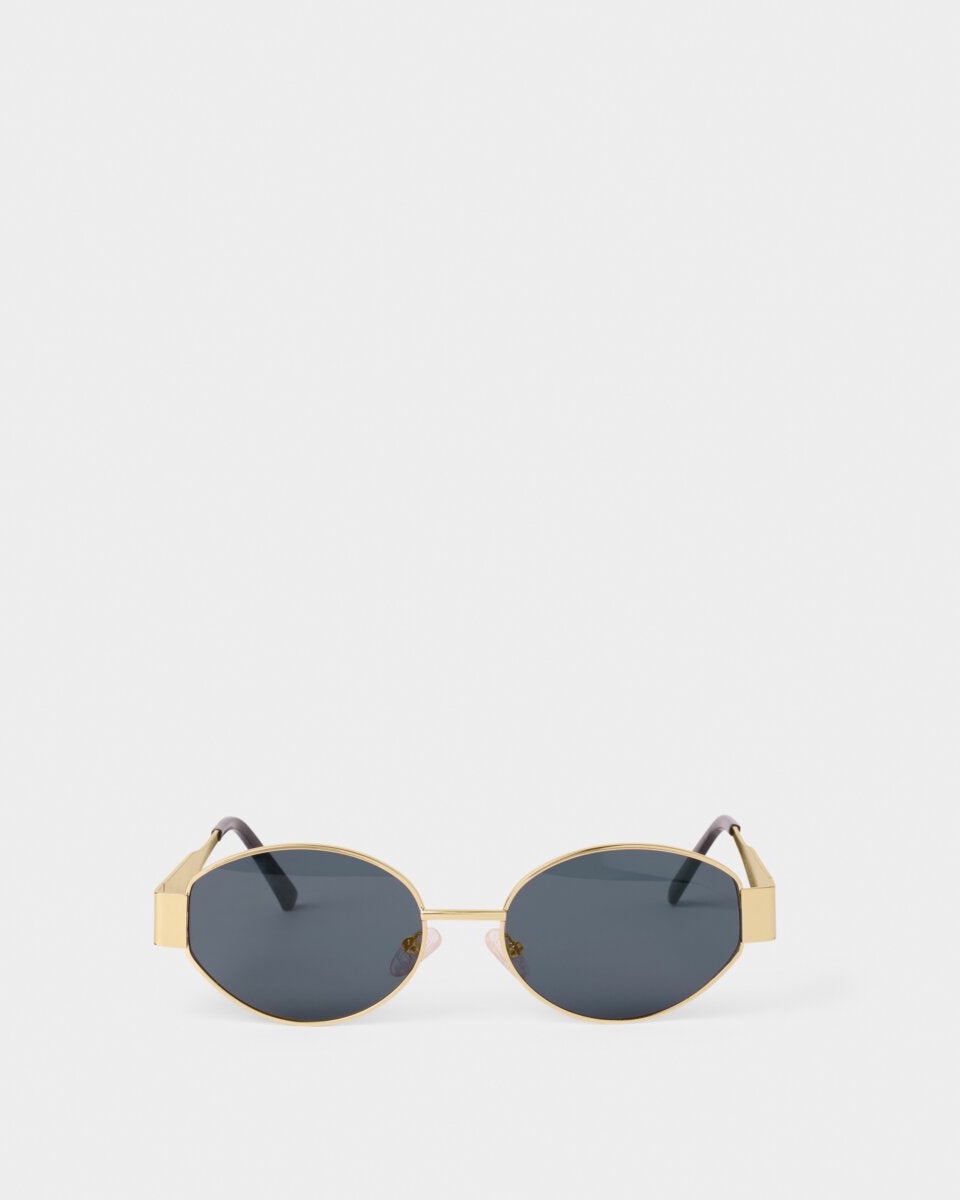 siena katie loxton Gold-framed sunglasses with dark lenses on a white background