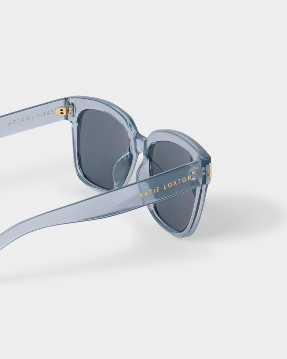 katie loxton Blue roma sunglasses with gold accents on a white background
