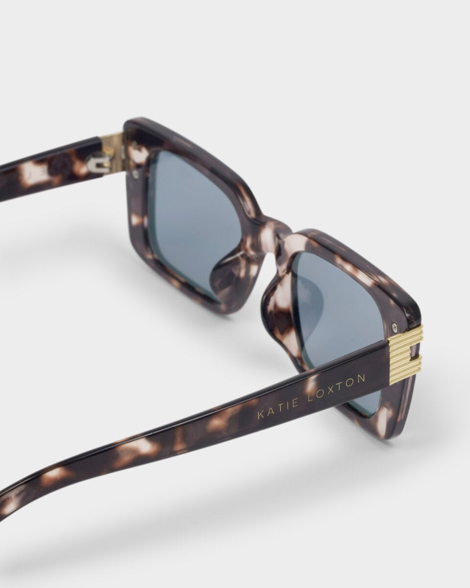 katie loxton malibu tortoiseshell Sunglasses with tortoiseshell frame and gold accents on a white background
