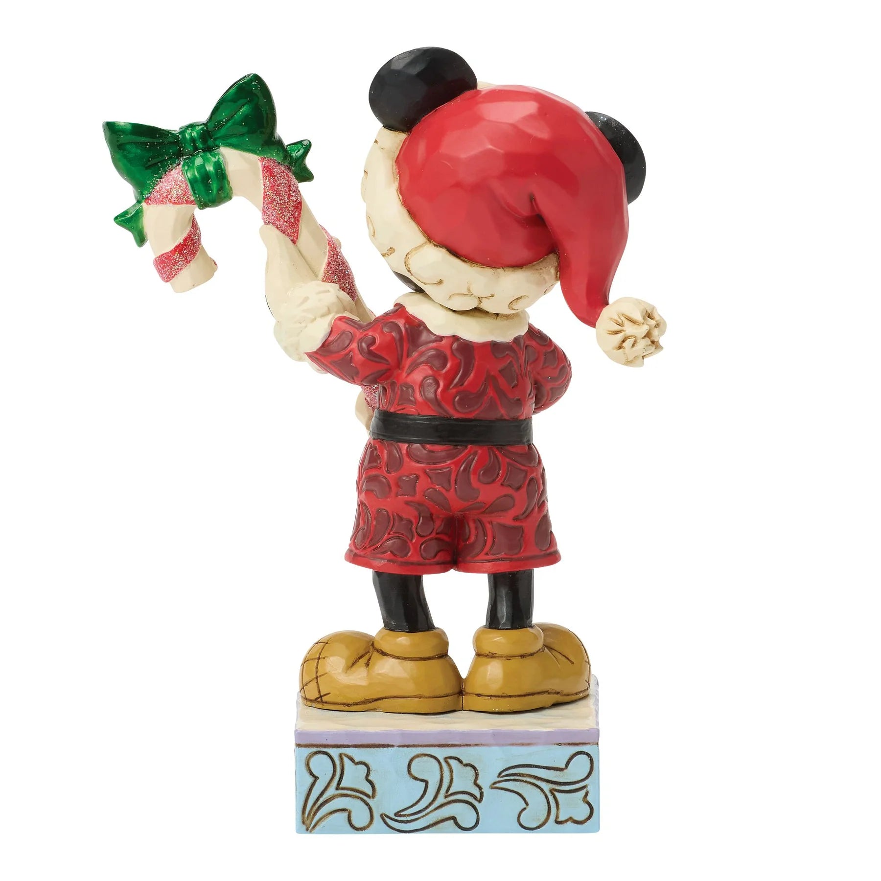 Mickey Mouse Figurine in a red Santa outfit with a candy cane and green bow on a white background