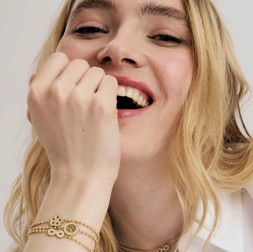 Woman with blonde hair wearing Nomination Italy Soffio A'more jewellery. On a plain background to advertise the collection