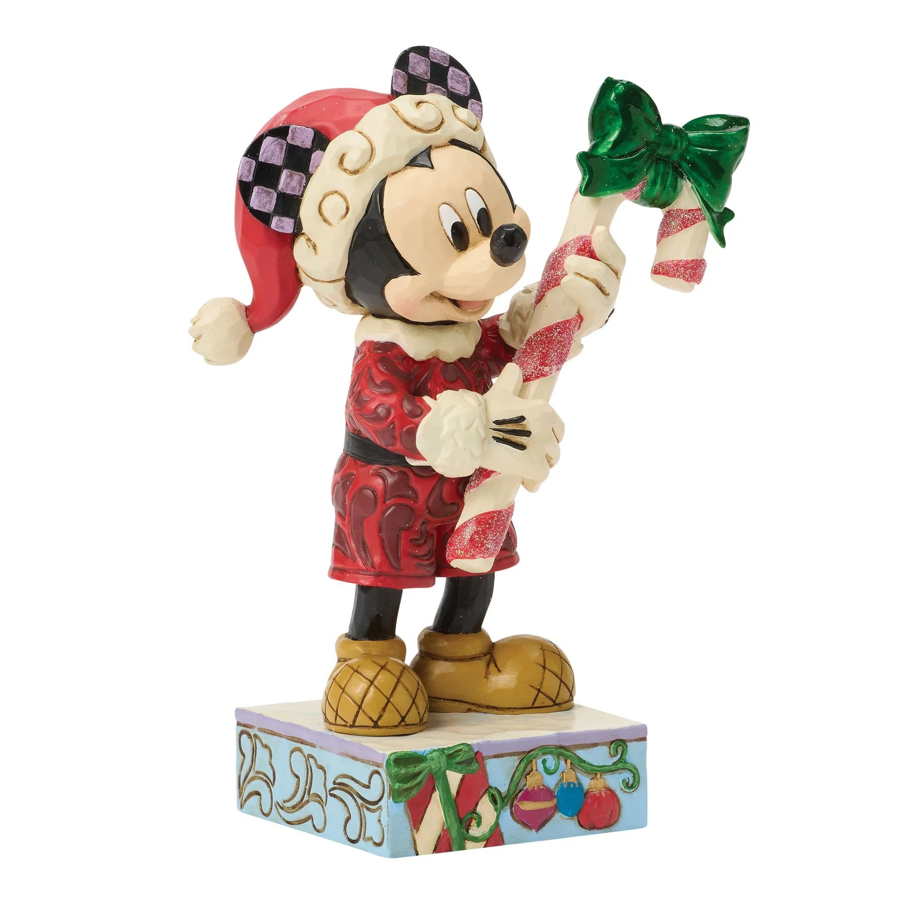 Mickey Mouse figurine in Christmas attire holding a candy cane on a white background
