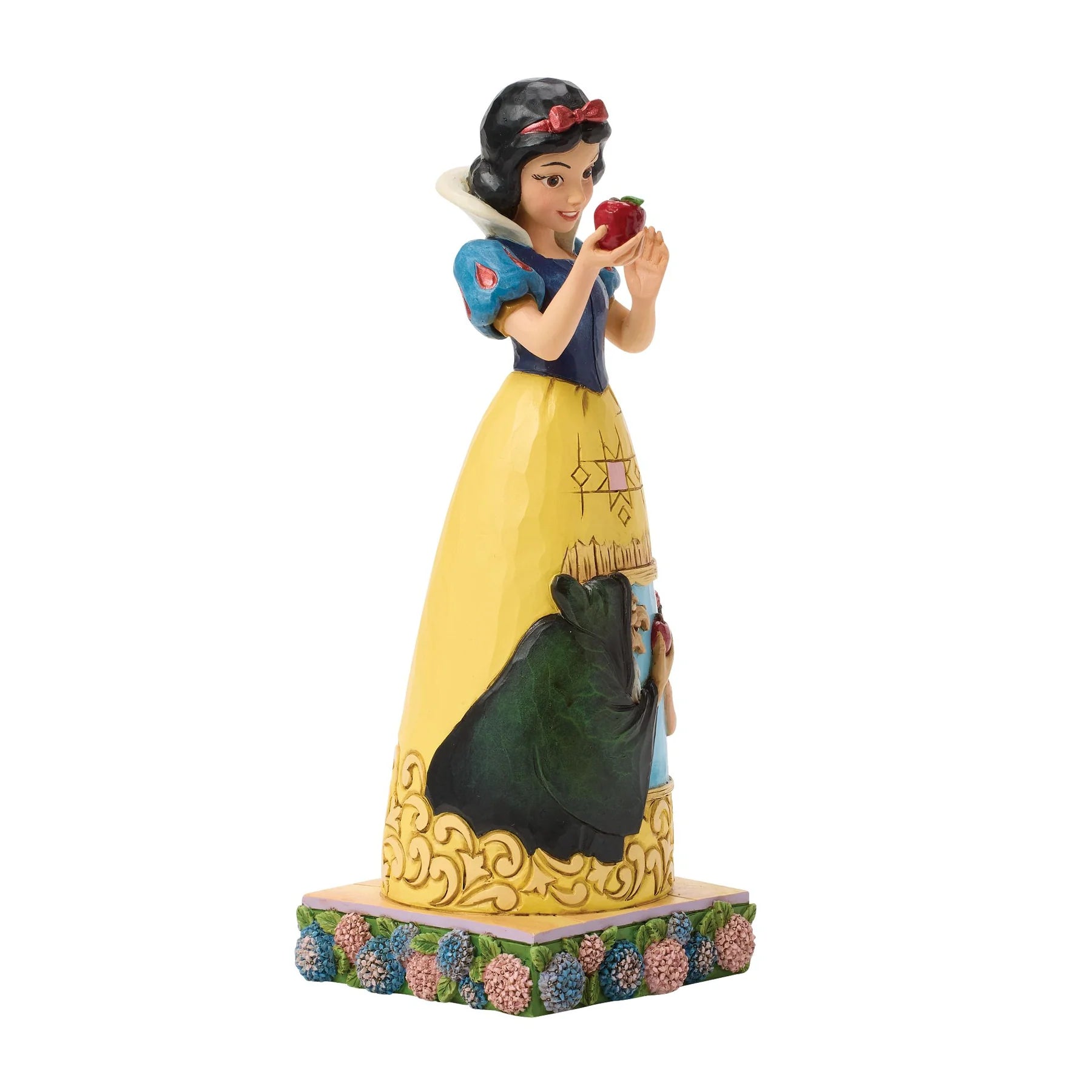 Snow White figurine holding an apple on a white background