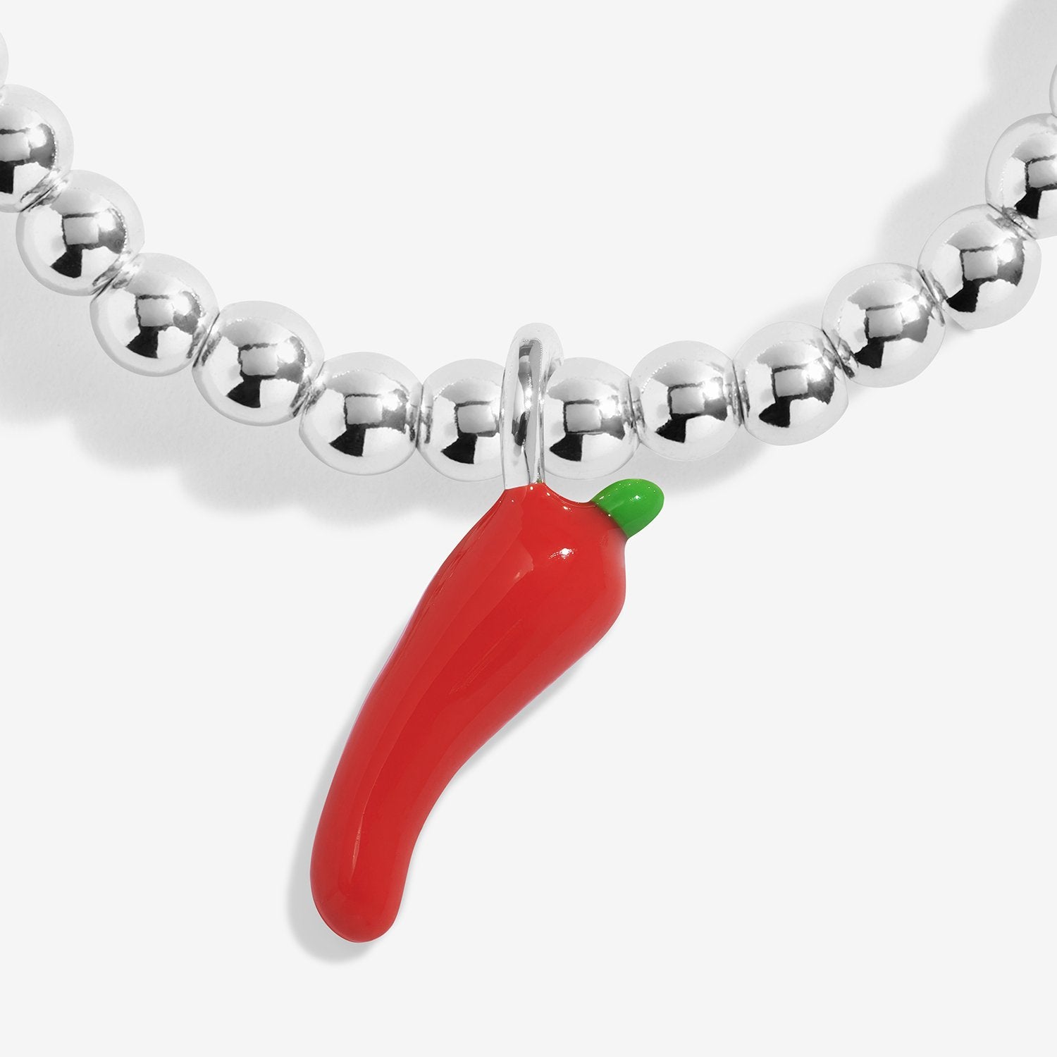 Silver-plated joma jewellery beaded bracelet with a red chili pepper charm on a white background