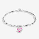 Silver bracelet with a pink and white checkered charm on a white background