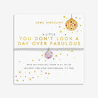 A Joma Jewellery bracelet displayed on its branded white card packaging. The bracelet features a silver-toned chain with a central disco ball charm containing pink, and white reflective facets.