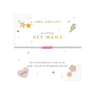 A Joma Jewellery 'A Little Hey Mama' bracelet displayed on its white gift card. The bracelet features pink and white woven cord with a silver-toned beaded center.