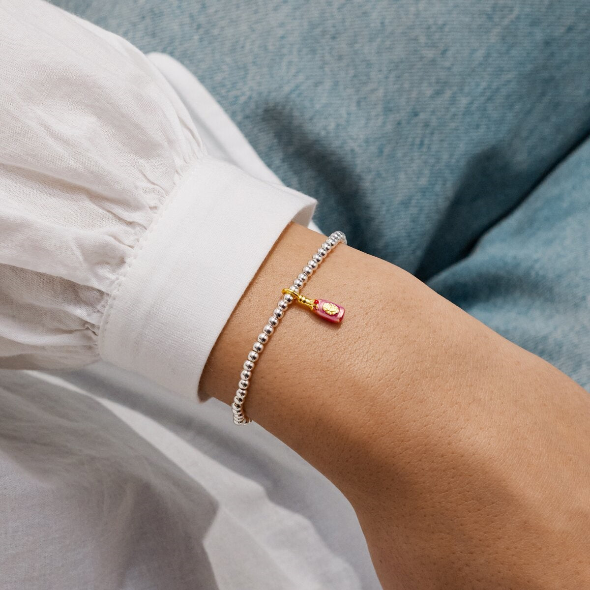 Close-up of a wrist wearing the silver plated prosec Ho Ho Ho  joma bracelet. 