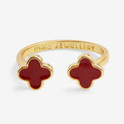 Gold ring with red clover-shaped stones on a white background, branded 'Joma Jewellery'.