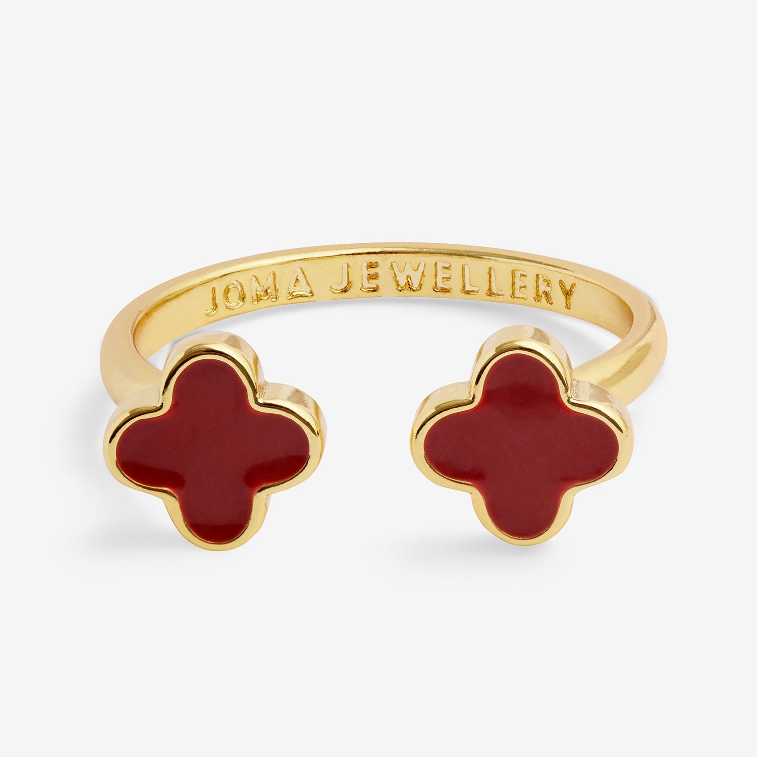 Gold ring with red clover-shaped stones on a white background, branded 'Joma Jewellery'.