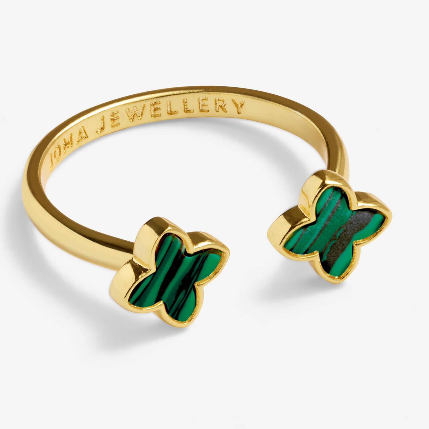 A gold open bangle ring featuring two butterfly-shaped inlays of green enamel stone, shown on a light gray background. The inside of the band is engraved with the brand name 'OMA JEWELLERY'.
