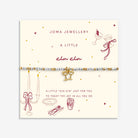 A delicate beaded Joma Jewellery bracelet with  gold coloured glasses  charm, presented on a cream-coloured card.