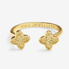 Gold ring with clover design on a white background, featuring Joma Jewellery branding.