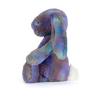 Purple,green,blue coloured Cosmic patterned plush jellycat luxe bunny on white background.