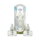 Two Yankee Candle refill bottles with white caps displayed in front of their original packaging box on a white background. The packaging features a graphic of a white cotton sheet with blue sky and green wildflower illustrations.