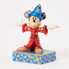 Figurine of a character in a red outfit and blue hat on a decorative base with geometric pattern