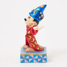 Mickey Mouse figurine in a wizard costume on a white background
