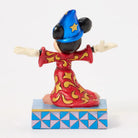 Figurine of a character in a red outfit with gold patterns and a blue hat on a white background