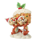 A festive figurine of Chip and  Dale wearing Santa hats and carrying a large decorated Christmas pudding on a snowy base, isolated on a white background.