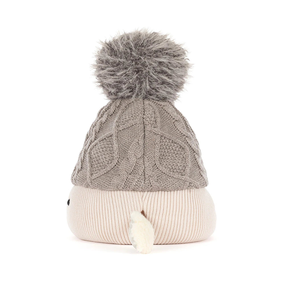 Jellycat amuseables pomilly hat with a gray cable-knit top, a cream ribbed bottom, a gray pom-pom, and small fabric hands and feet, shown on a white background.