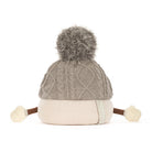 Jellycat amuseables pomilly hat with a gray cable-knit top, a cream ribbed bottom, a gray pom-pom, and small fabric hands and feet, shown on a white background. A side tag reads JELLYCAT.
