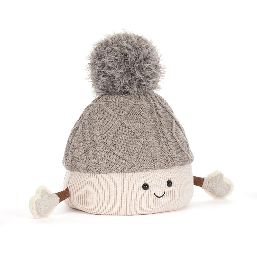 Jellycat amuseables pomilly hat with a gray cable-knit top, a cream ribbed bottom, a gray pom-pom, and small fabric hands and feet, shown on a white background.
