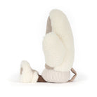 Side view of Jellycat amuseables winter mitten toy in a warm taupe-brown fabric with cream sherpa trim, featuring a simple embroidered smiley face and small feet, shown on a clean white background.