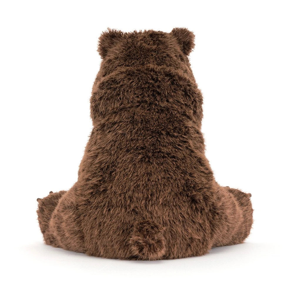 Jellcat Bizzlestomp is brown plush teddy bear. Its shown from the back, sitting down, on a clean white background.
