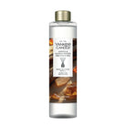 A Yankee Candle Amber & Sandalwood reed diffuser refill bottle with a gold cap, shown on a plain white background.