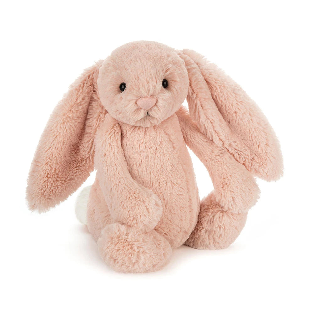 A plush stuffed Jellycat bunny in a soft blush pink colour, sitting upright against a clean white background.