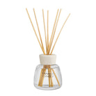 Yankee Candle reed diffuser with a clear glass bottle, cream-colored cap, and natural bamboo reeds, shown on a solid white background.