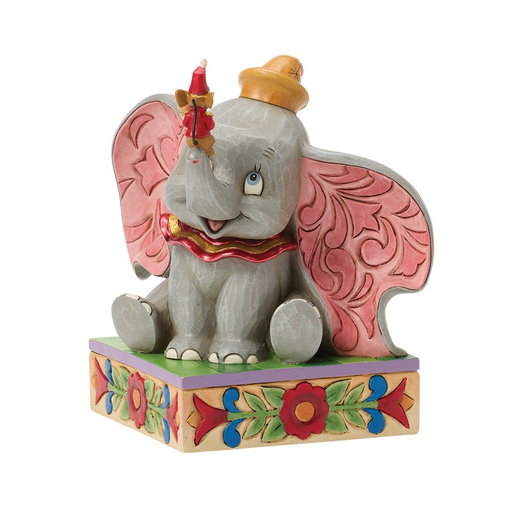 Decorative Dumbo elephant figurine with colorful pink ears on a white background