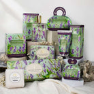 Collection of English Lavender themed products including soap, candles, and packaging on a neutral background.